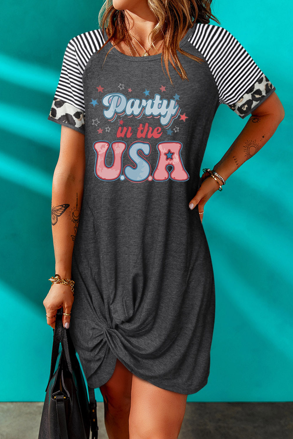 A stylish PARTY IN THE USA Graphic Twisted Dress featuring a striped pattern, round neckline, and asymmetrical hem, perfect for casual outings.