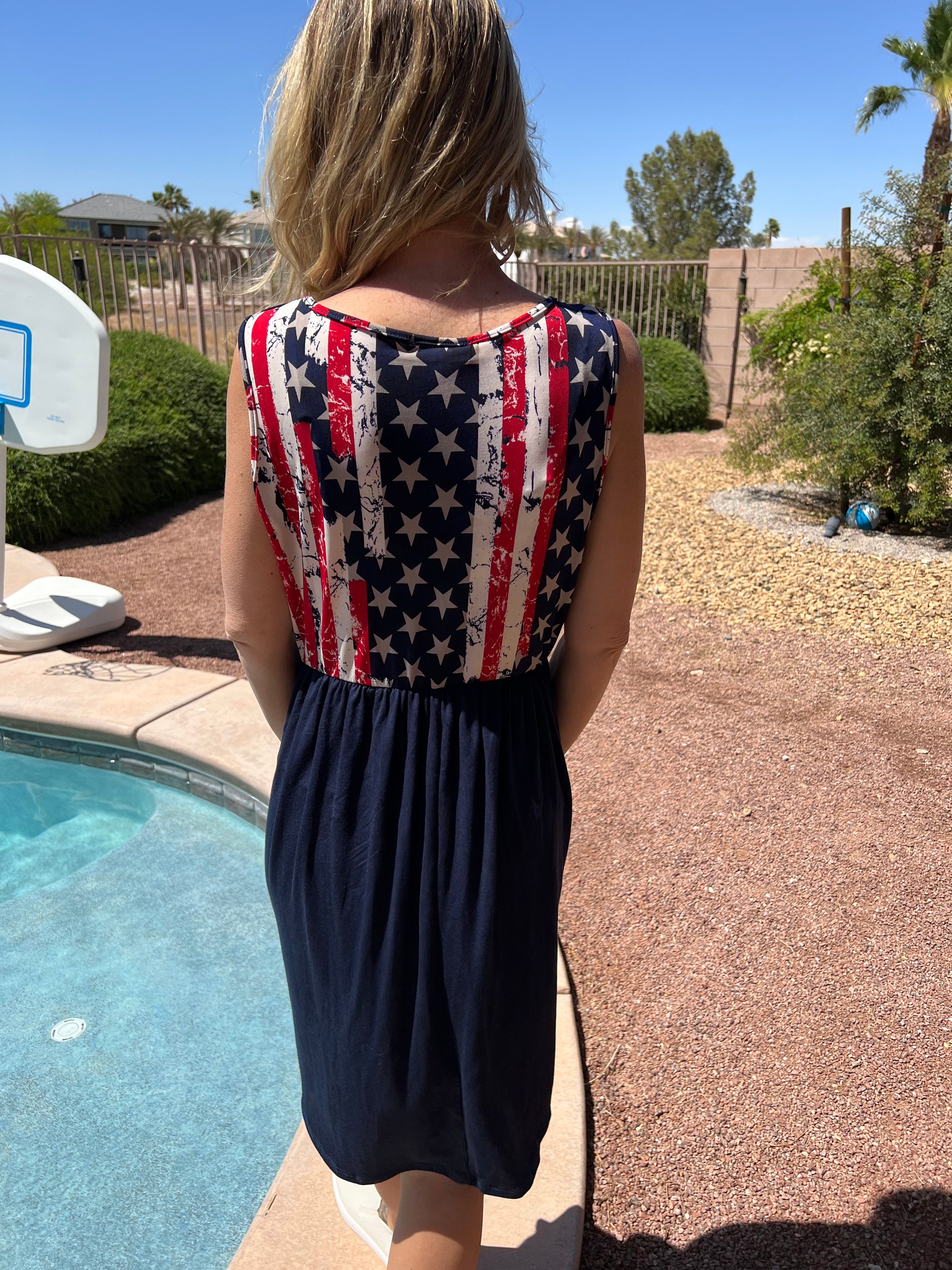 A stylish patriotic knit dress featuring an elastic waist and tank style design, perfect for summer celebrations.