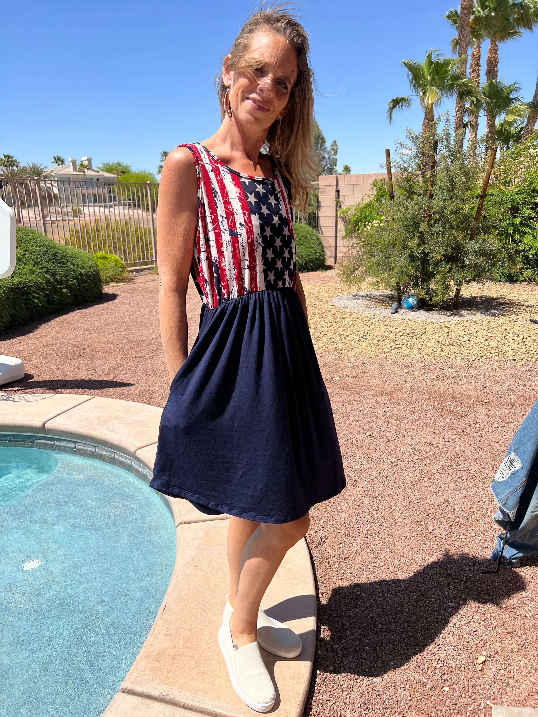 A stylish patriotic knit dress featuring an elastic waist and tank style design, perfect for summer celebrations.