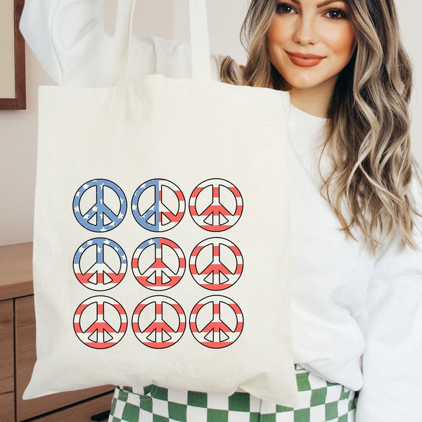 Colorful canvas tote bag featuring peace signs in red, white, and blue, perfect for summer and patriotic celebrations.