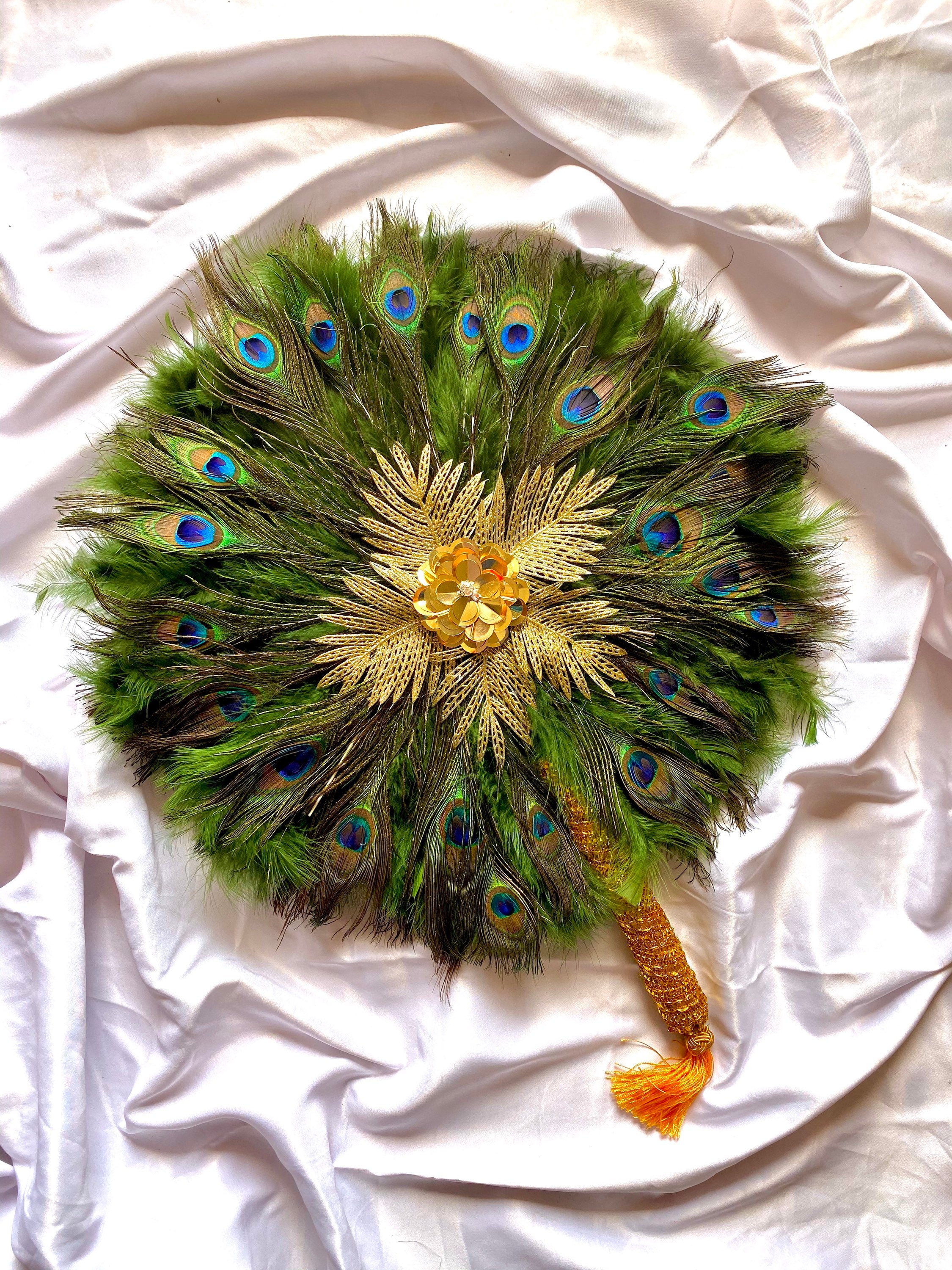 A beautiful 20-inch peacock feather hand fan with vibrant colors and an elegant design, featuring an 8-inch handle for easy use.