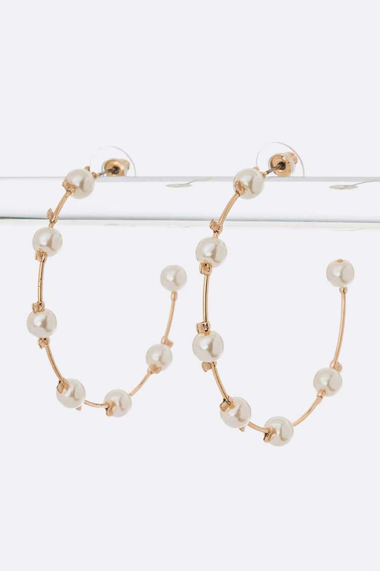 Elegant Pearl Hoop Earrings with a 2" drop, showcasing a classic design with pearl accents.