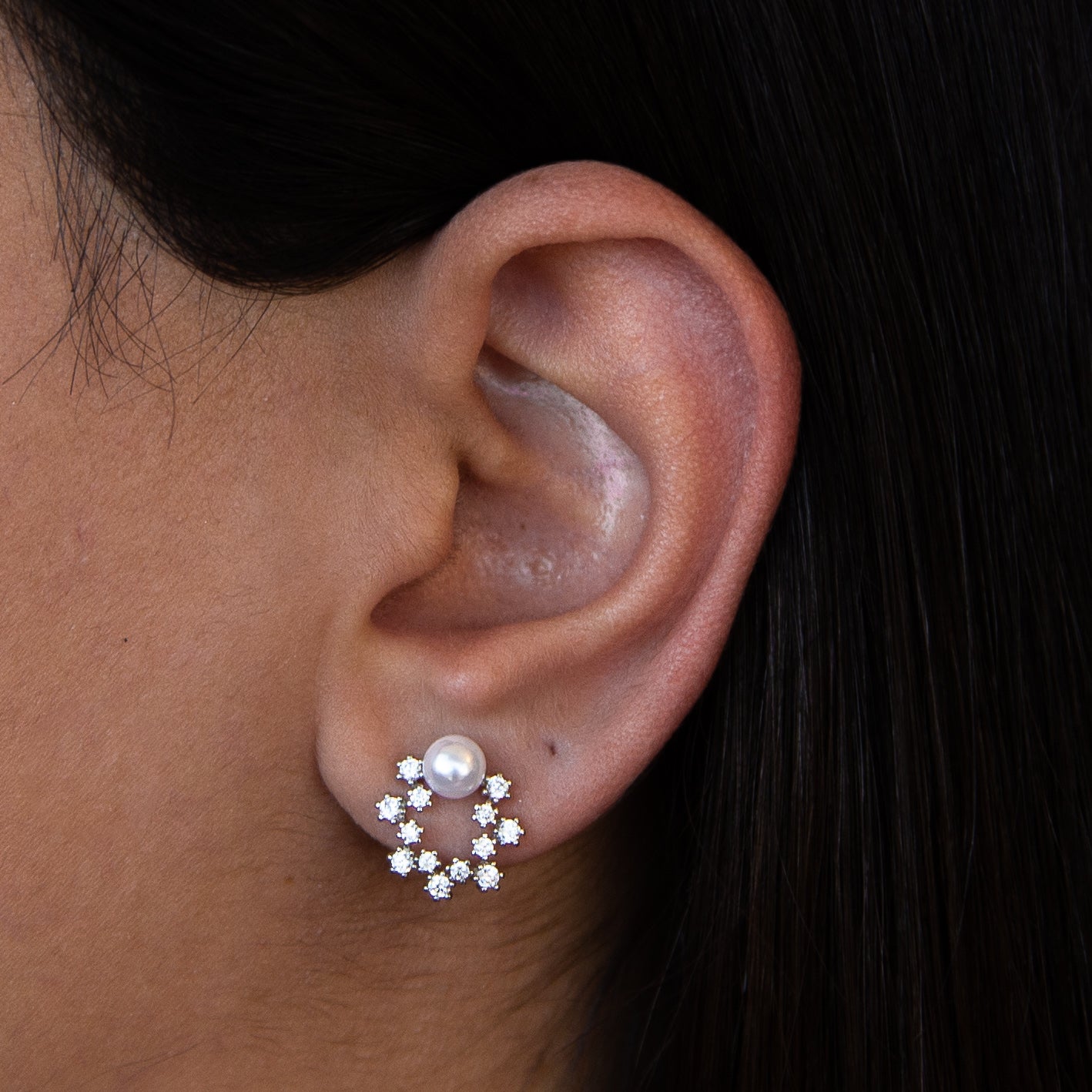 A pair of elegant white gold earrings with a pearlescent finish, showcasing Italian craftsmanship.