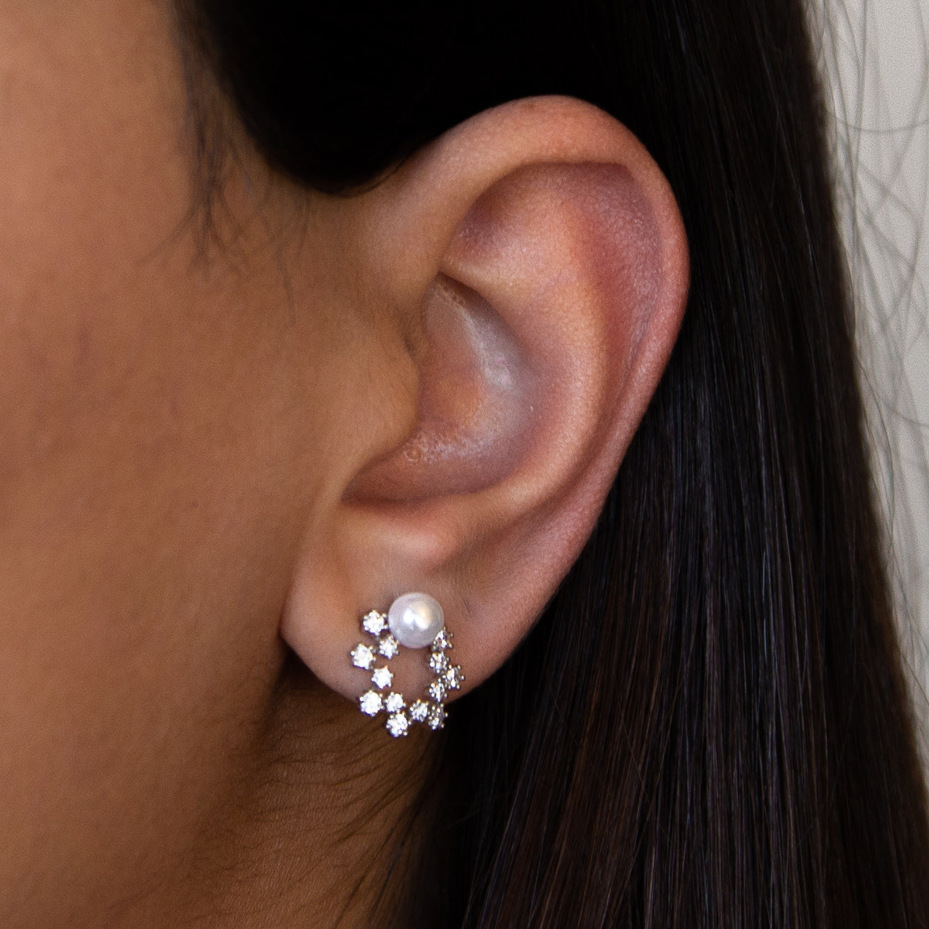 A pair of elegant white gold earrings with a pearlescent finish, showcasing Italian craftsmanship.