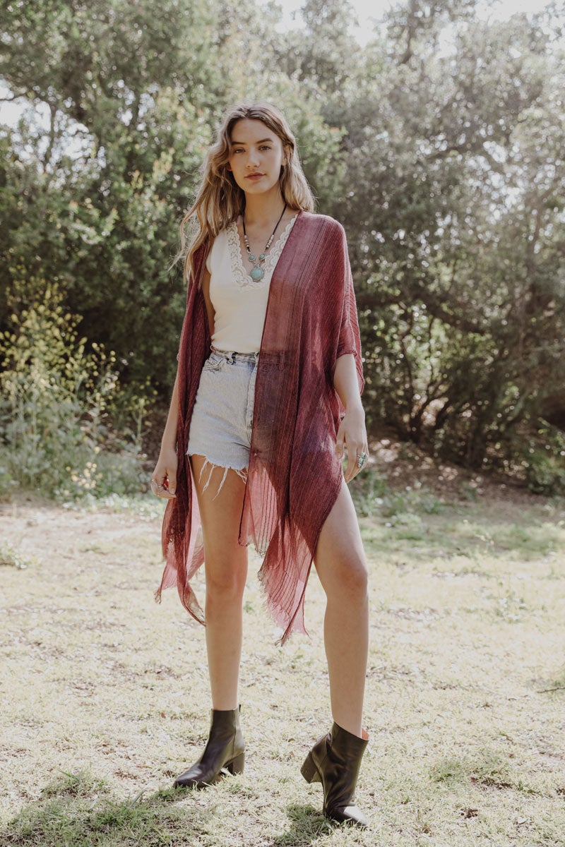 A stylish Pencil Stripe Lurex Trim Kimono featuring a chic pencil stripe pattern and elegant lurex trim, perfect for summer outings.