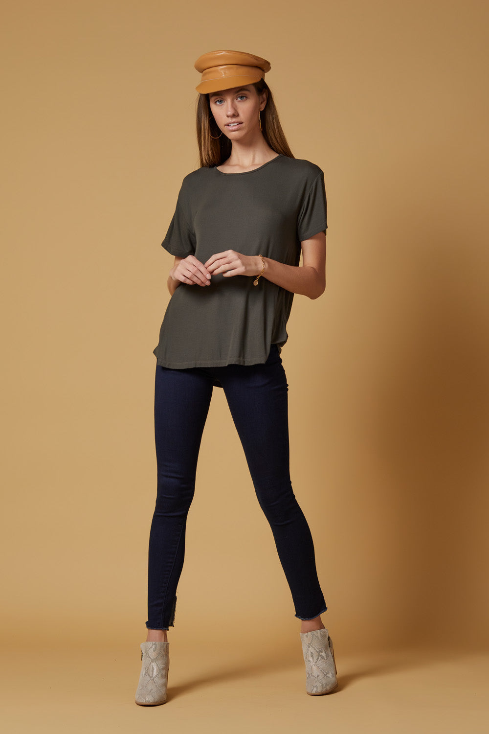 A pair of Perfect Fit Raw Hem Skinnies in deep indigo, featuring a high-rise slim-straight fit and unique raw hem detailing.