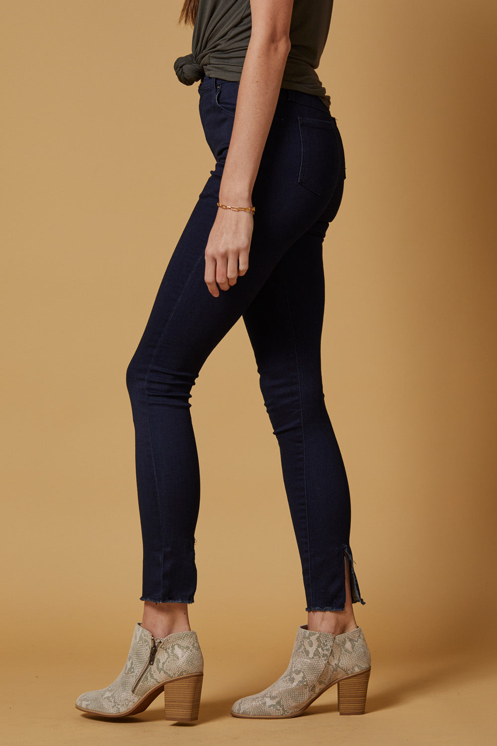 A pair of Perfect Fit Raw Hem Skinnies in deep indigo, featuring a high-rise slim-straight fit and unique raw hem detailing.