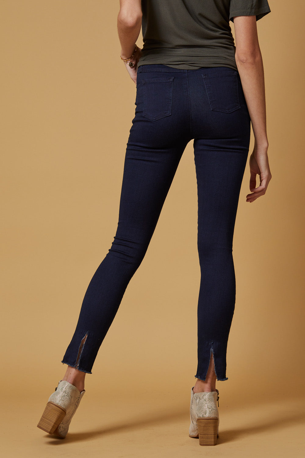 A pair of Perfect Fit Raw Hem Skinnies in deep indigo, featuring a high-rise slim-straight fit and unique raw hem detailing.