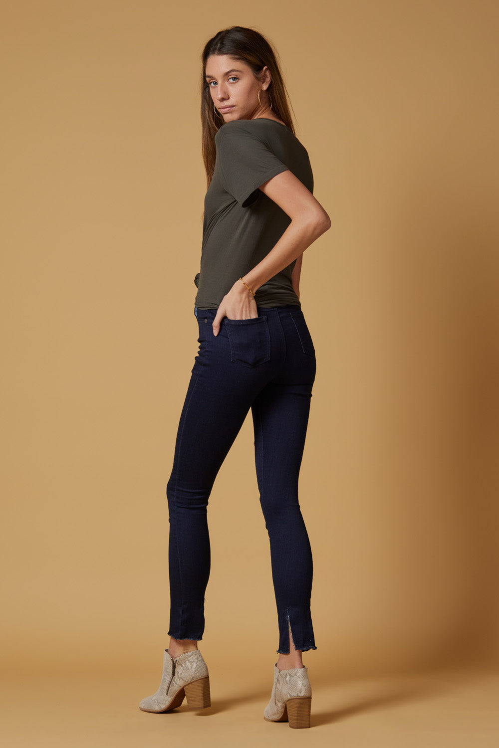 A pair of Perfect Fit Raw Hem Skinnies in deep indigo, featuring a high-rise slim-straight fit and unique raw hem detailing.