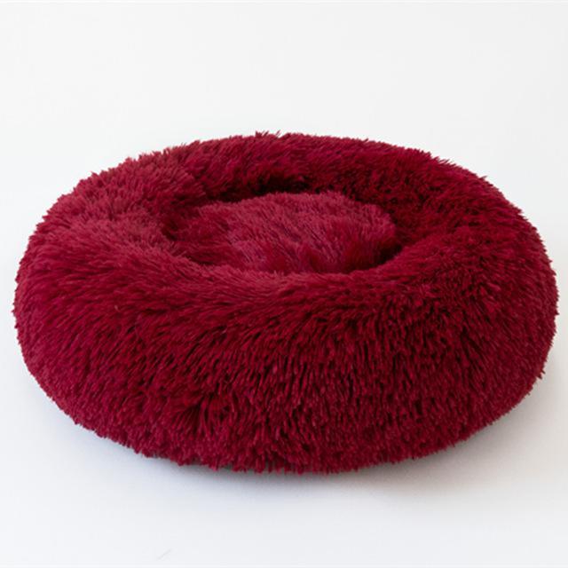 A cozy round dog bed in soft corduroy material, designed for comfort and security, perfect for small to medium-sized dogs.