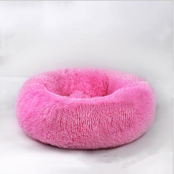 A cozy round dog bed in soft corduroy material, designed for comfort and security, perfect for small to medium-sized dogs.