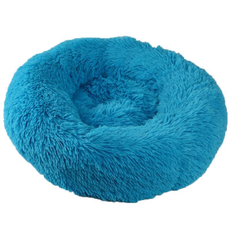 A cozy round dog bed in soft corduroy material, designed for comfort and security, perfect for small to medium-sized dogs.