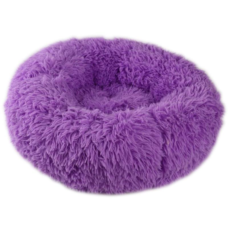 A cozy round dog bed in soft corduroy material, designed for comfort and security, perfect for small to medium-sized dogs.