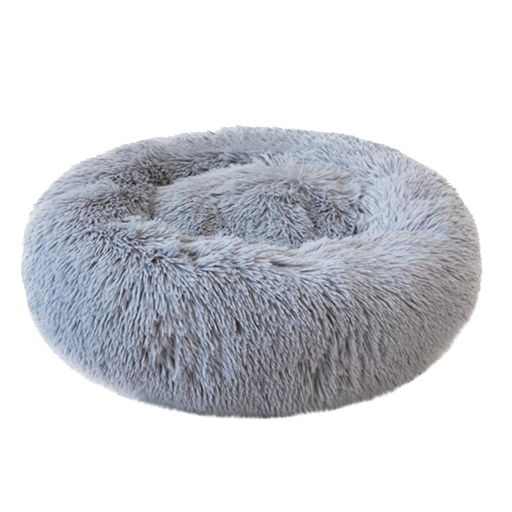 A cozy round dog bed in soft corduroy material, designed for comfort and security, perfect for small to medium-sized dogs.