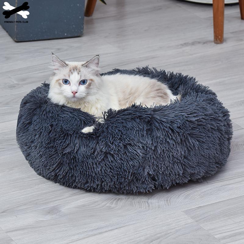 A cozy round dog bed in soft corduroy material, designed for comfort and security, perfect for small to medium-sized dogs.