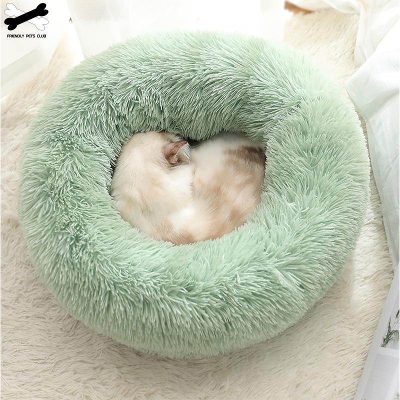 A cozy round dog bed in soft corduroy material, designed for comfort and security, perfect for small to medium-sized dogs.