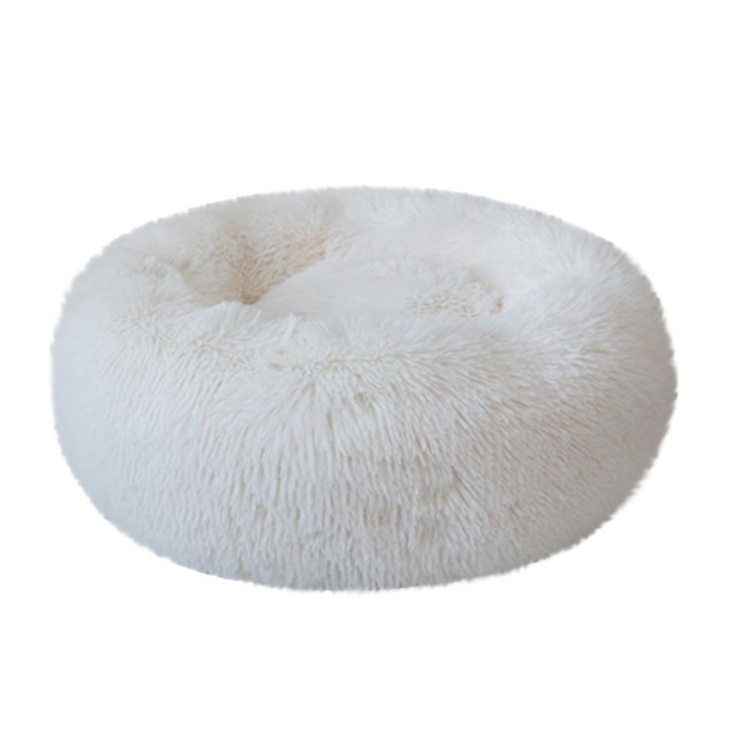 A cozy round dog bed in soft corduroy material, designed for comfort and security, perfect for small to medium-sized dogs.