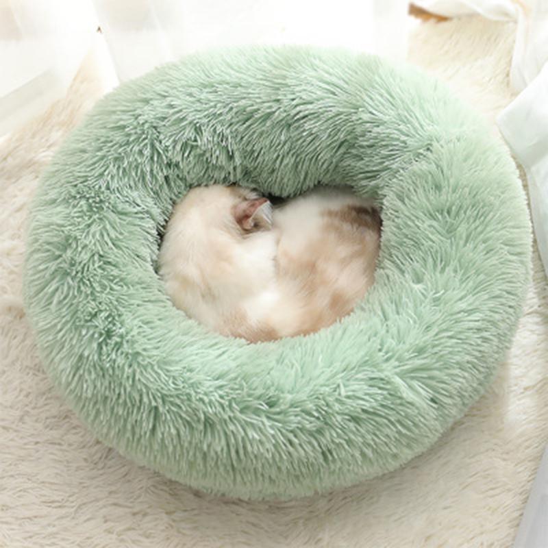 A cozy round dog bed in soft corduroy material, designed for comfort and security, perfect for small to medium-sized dogs.