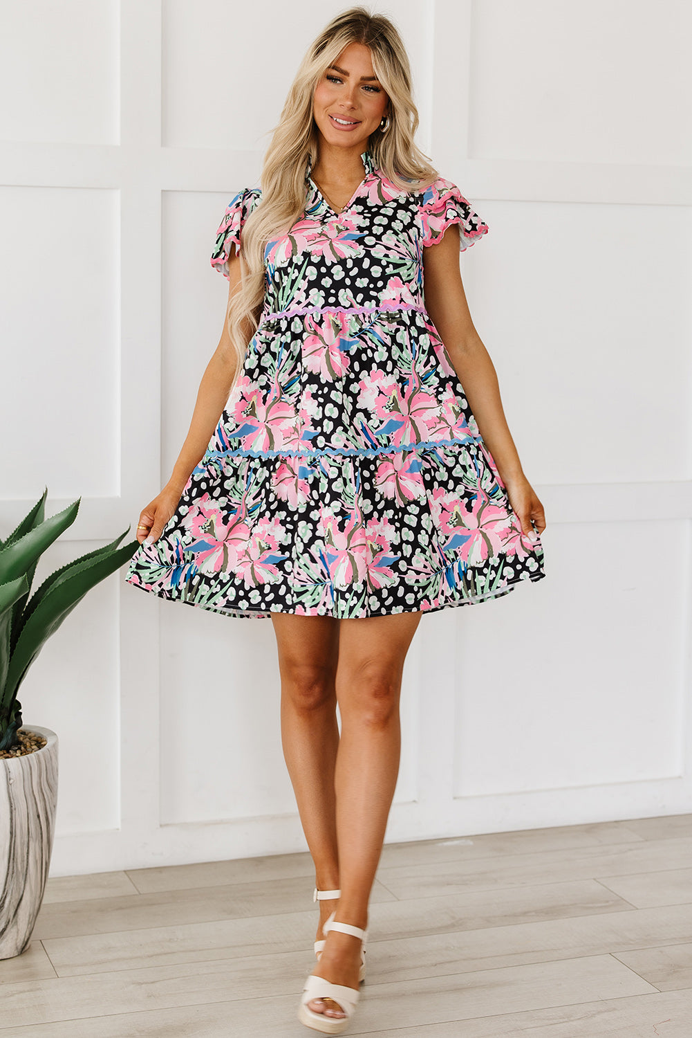 A stylish pink floral mini dress with ricrac embellishments, featuring a tiered design and short sleeves, perfect for casual outings.