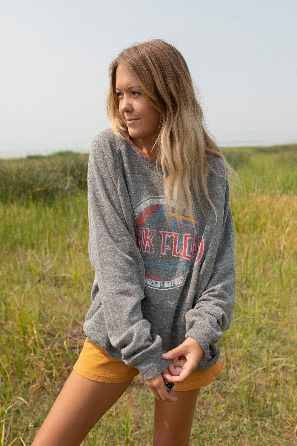 A stylish Pink Floyd oversized sweatshirt in heather gray, featuring a crew neck and iconic logo, made from 100% organic cotton.