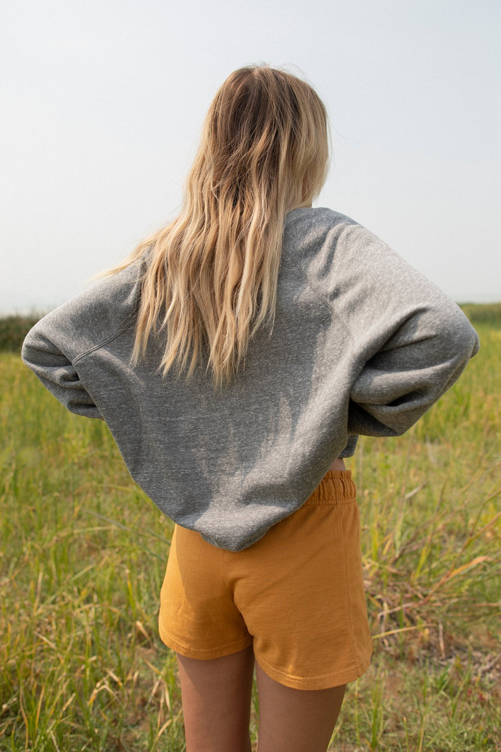 A stylish Pink Floyd oversized sweatshirt in heather gray, featuring a crew neck and iconic logo, made from 100% organic cotton.