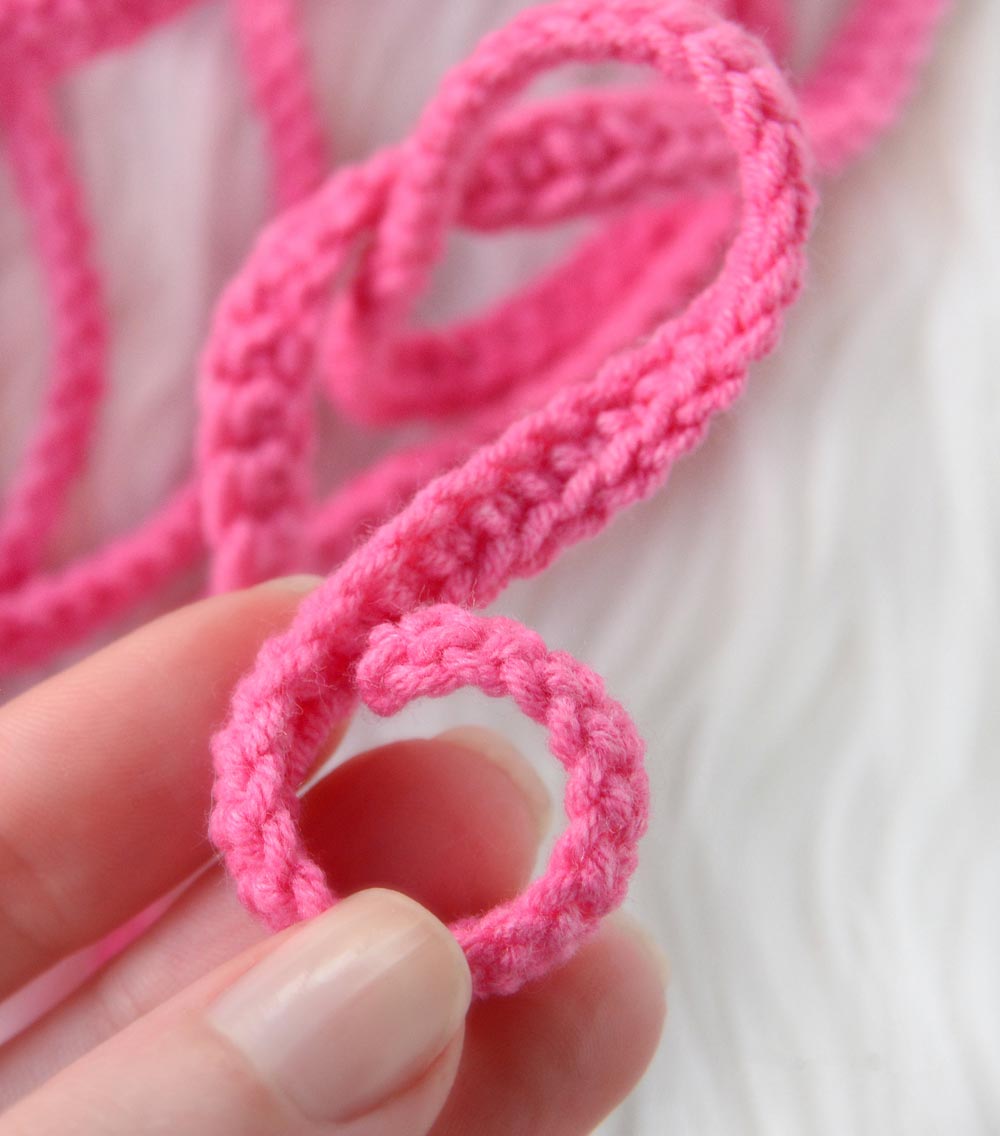 A vibrant pink micro slingshot bikini made from 100% cotton, showcasing its unique design and comfortable fit.