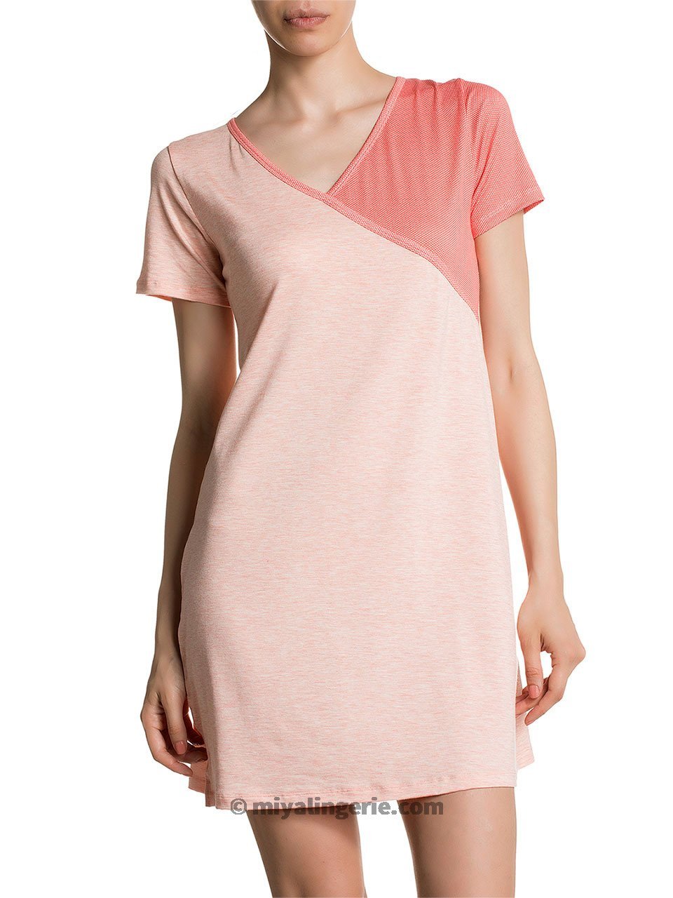 A stylish pink midi T shirt dress displayed on a mannequin, showcasing its soft fabric and versatile design.