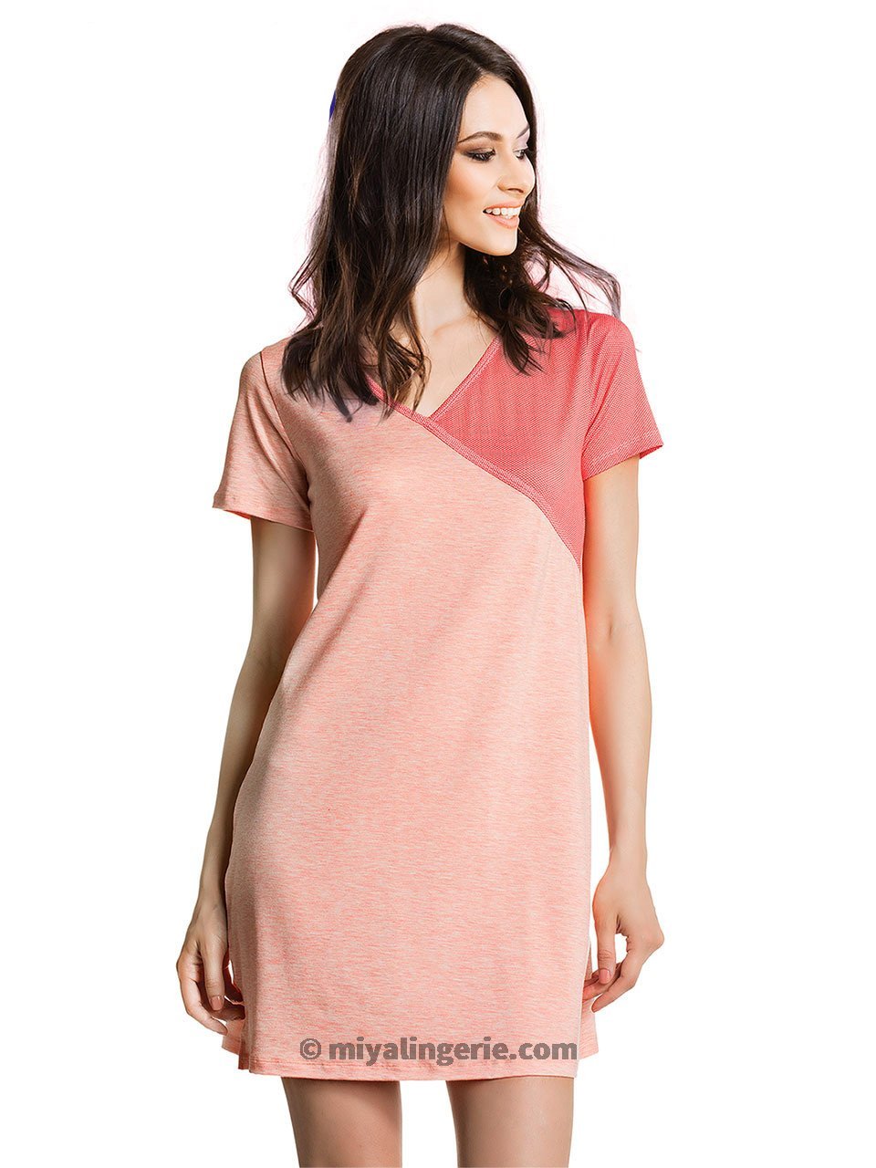 A stylish pink midi T shirt dress displayed on a mannequin, showcasing its soft fabric and versatile design.