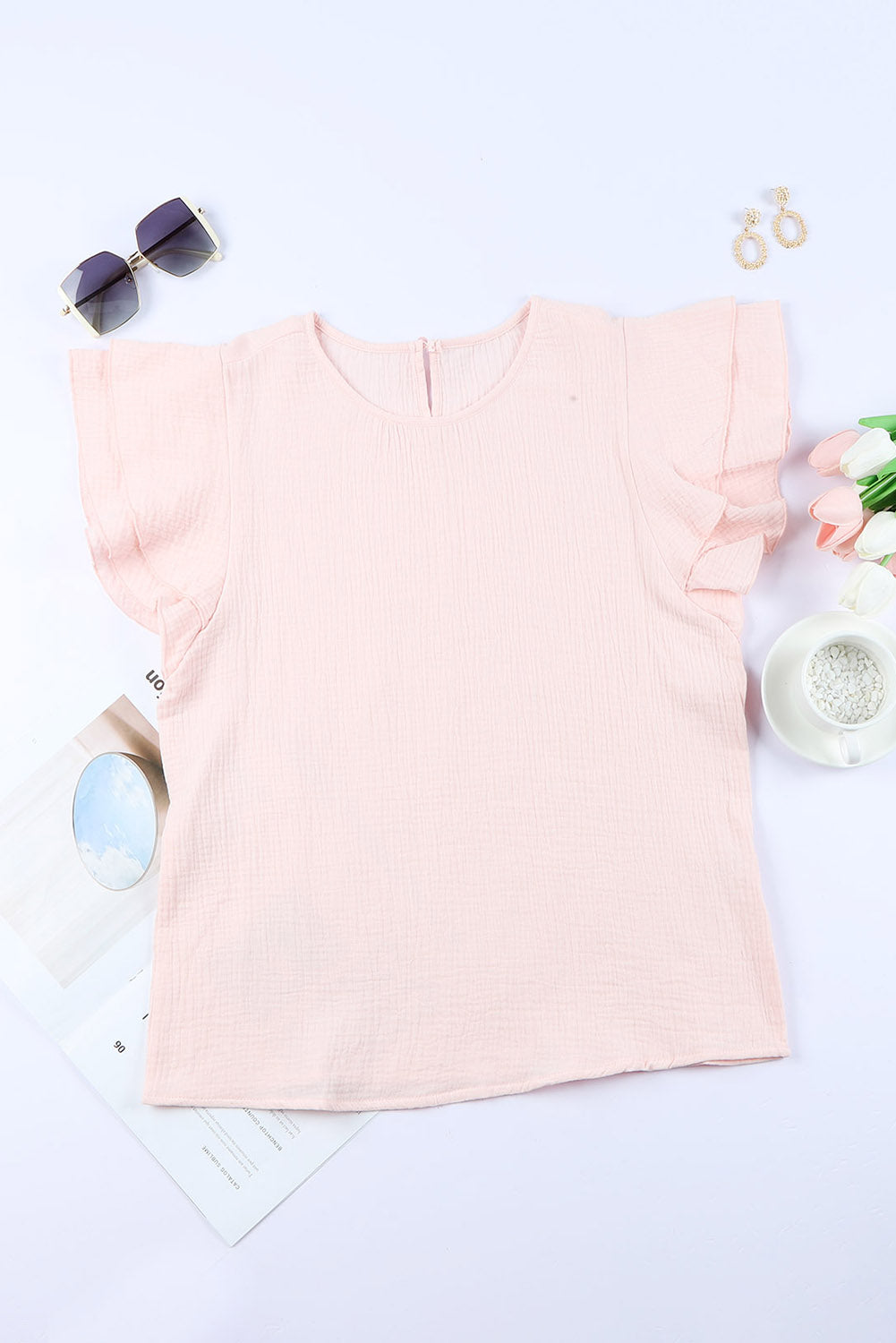 A stylish pink blouse featuring tiered ruffled sleeves and textured details, perfect for casual and formal occasions.