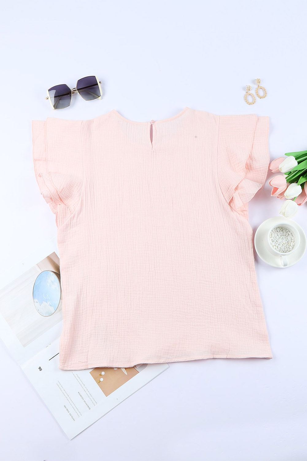 A stylish pink blouse featuring tiered ruffled sleeves and textured details, perfect for casual and formal occasions.