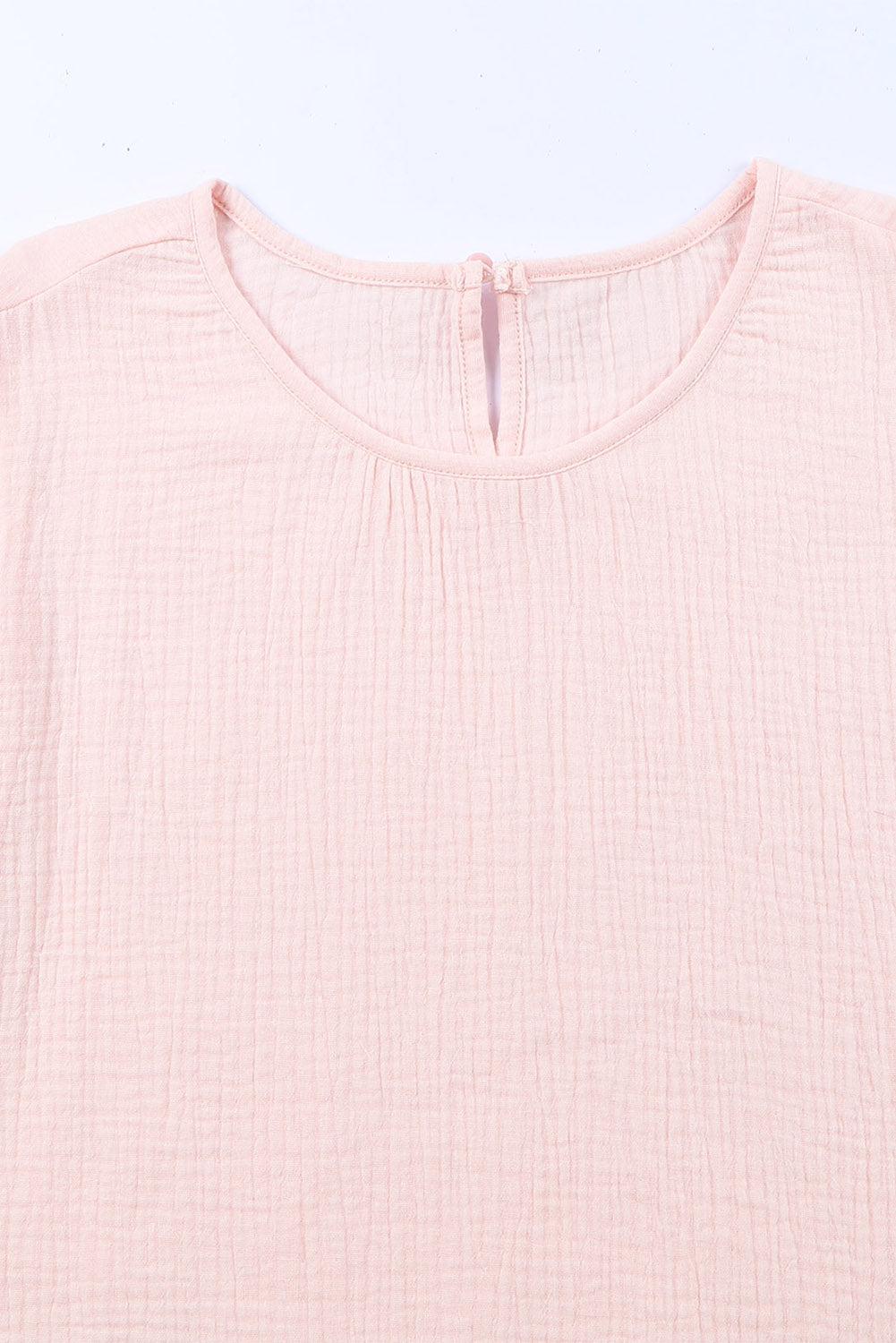 A stylish pink blouse featuring tiered ruffled sleeves and textured details, perfect for casual and formal occasions.