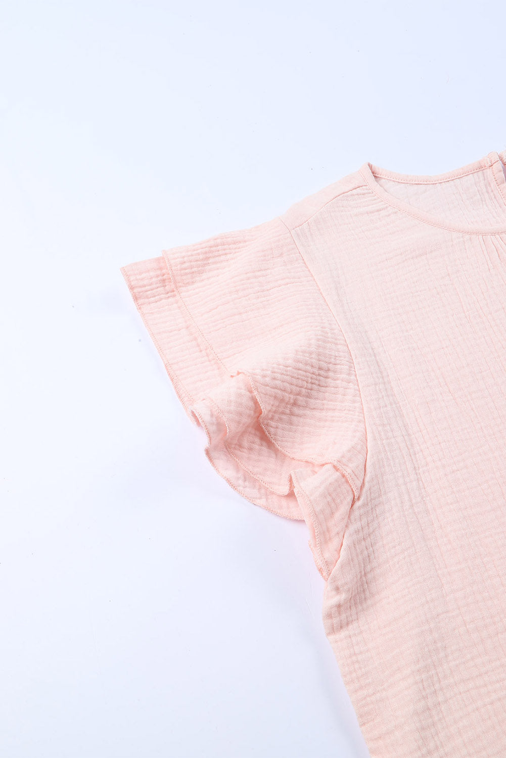 A stylish pink blouse featuring tiered ruffled sleeves and textured details, perfect for casual and formal occasions.