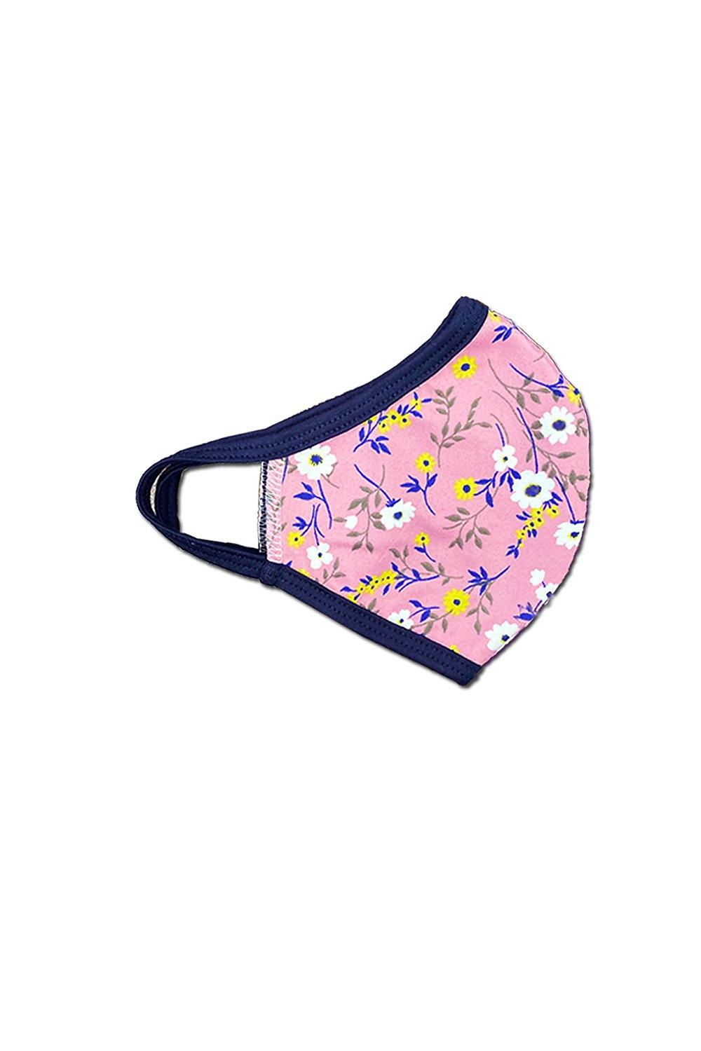 Pink and white floral face mask made from breathable fabric, featuring elastic ear bands for a secure fit.