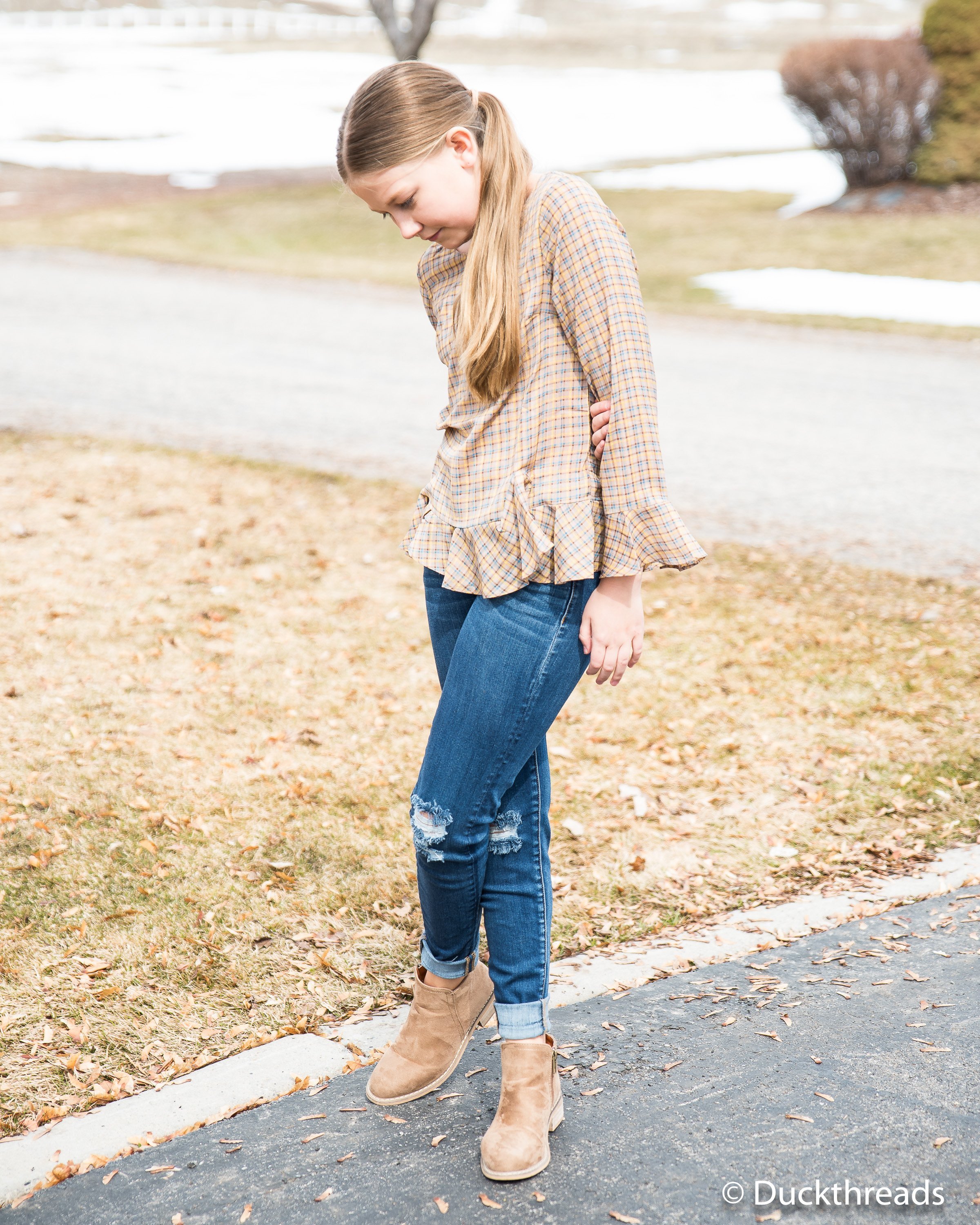 A stylish plaid bell sleeve top made from 100% polyester, featuring a trendy design and comfortable fit.