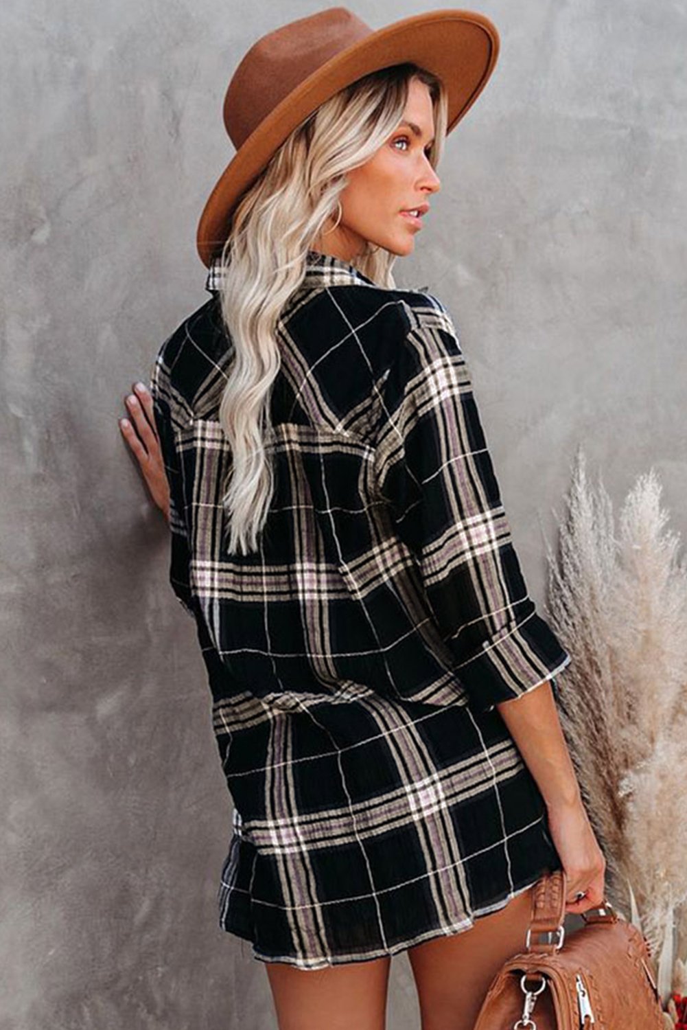 A stylish plaid button shirt in black, showcasing its classic design and comfortable fabric, perfect for various occasions.