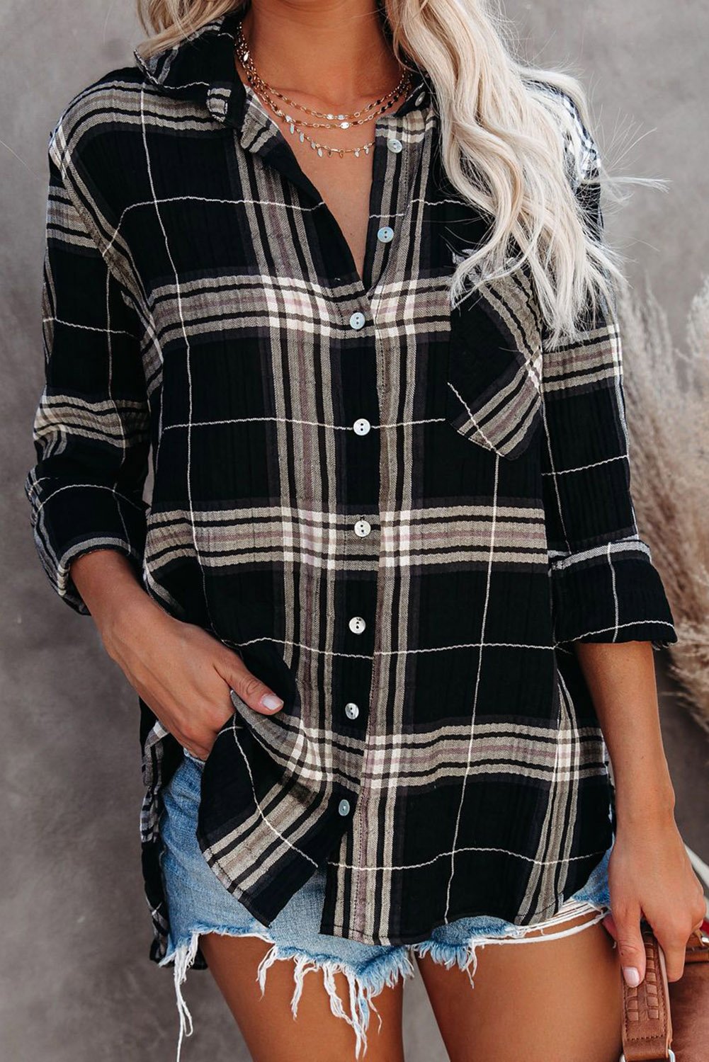 A stylish plaid button shirt in black, showcasing its classic design and comfortable fabric, perfect for various occasions.