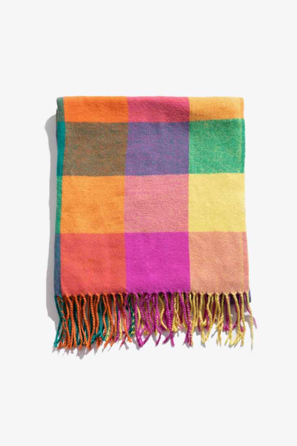 A stylish plaid fringe hem scarf laid flat, showcasing its vibrant colors and soft texture.