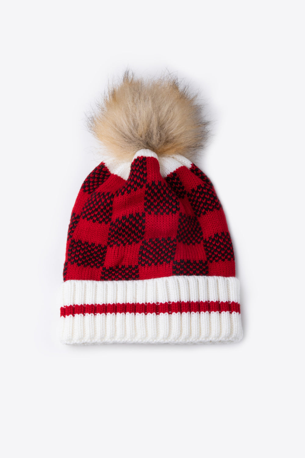 A stylish plaid pom-pom knit beanie in a flat lay style, showcasing its soft acrylic material and trendy design.