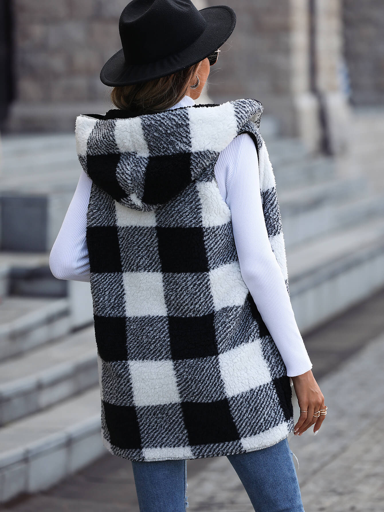 Plaid Reversible Front Hooded Fleece Vest displayed outdoors, showcasing its stylish design and pockets.