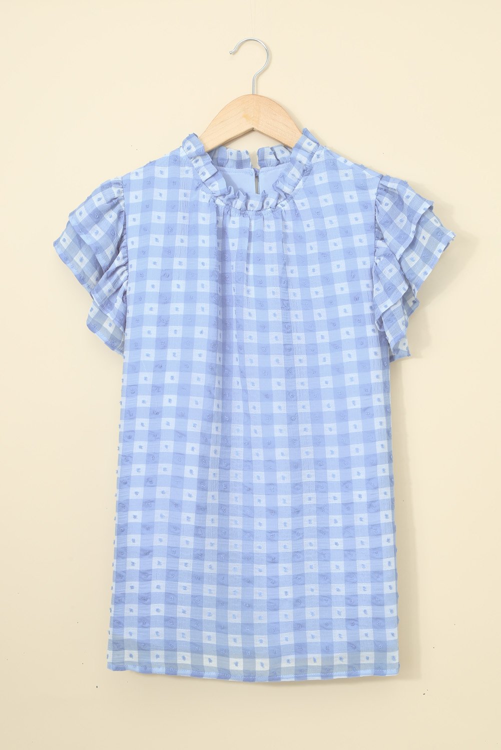 A stylish plaid ruffled short sleeves tee featuring a high rounded neckline and button closure at the back, perfect for casual wear.