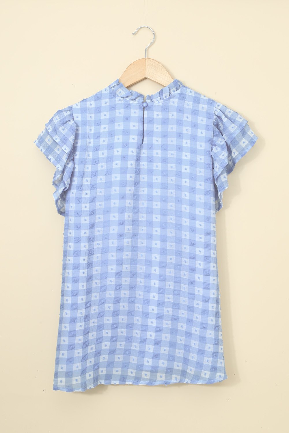 A stylish plaid ruffled short sleeves tee featuring a high rounded neckline and button closure at the back, perfect for casual wear.