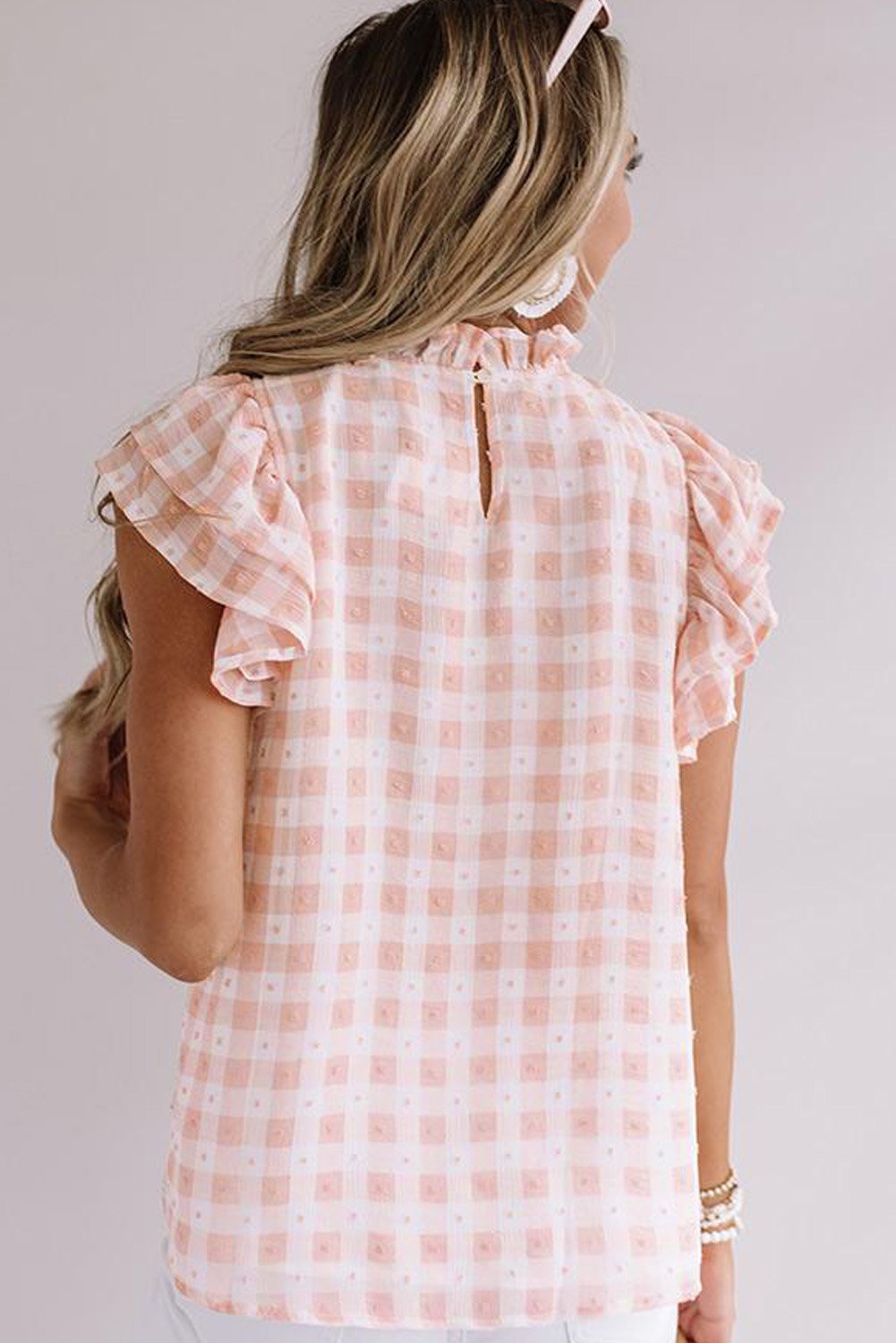 A stylish plaid ruffled short sleeves tee featuring a high rounded neckline and button closure at the back, perfect for casual wear.