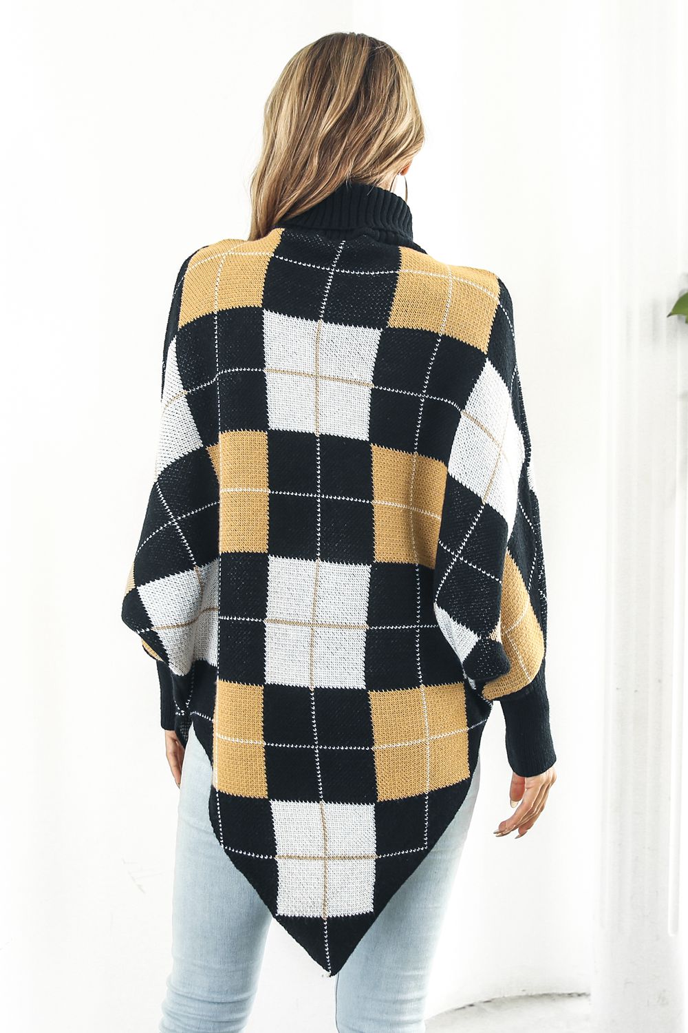 Plaid Turtleneck Dolman Sleeve Poncho in stylish plaid pattern, showcasing its cozy design and dolman sleeves.