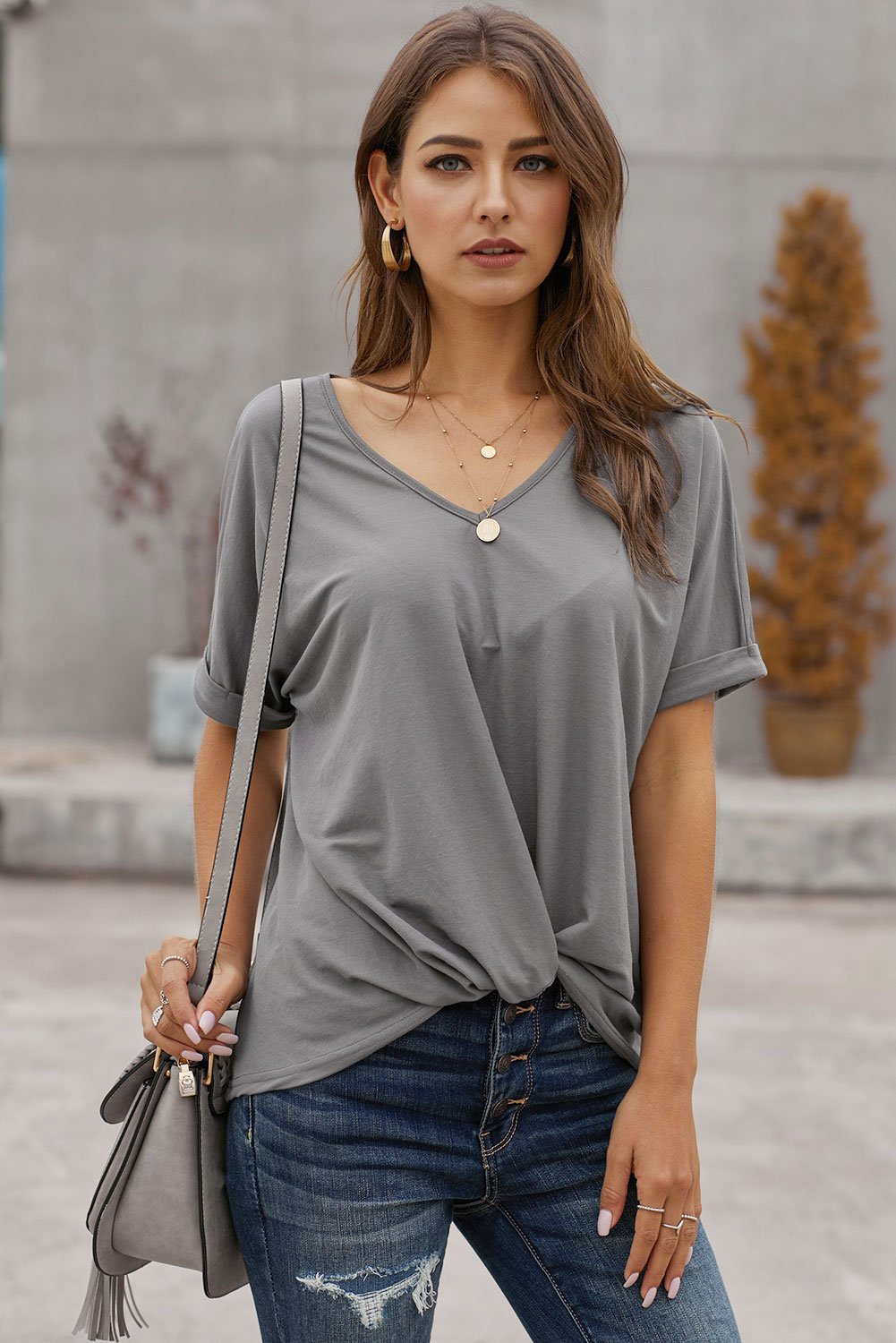 A stylish Plain Short Sleeve Twist Tee featuring a unique twist design, scoop neck, and kangaroo pouch, perfect for autumn wear.