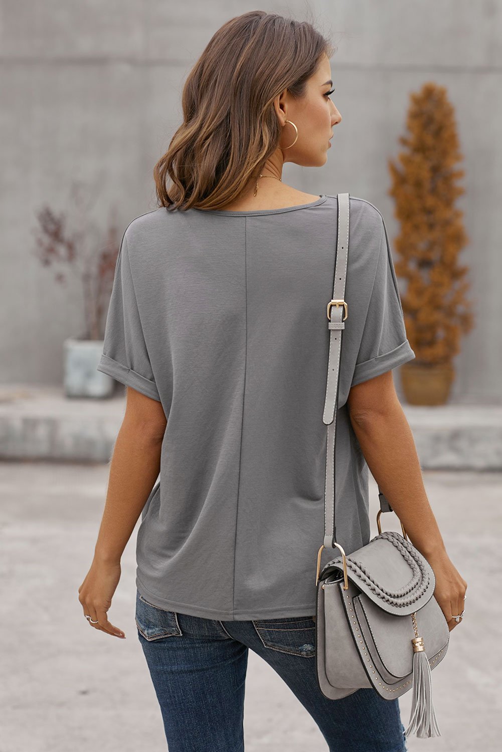 A stylish Plain Short Sleeve Twist Tee featuring a unique twist design, scoop neck, and kangaroo pouch, perfect for autumn wear.