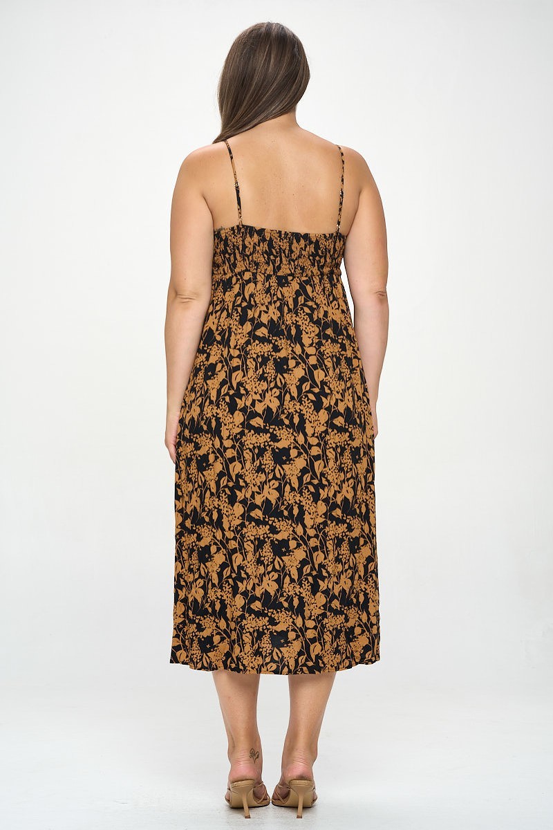 A stylish plus-size maxi dress featuring a botanical print and a front tie detail, perfect for various occasions.