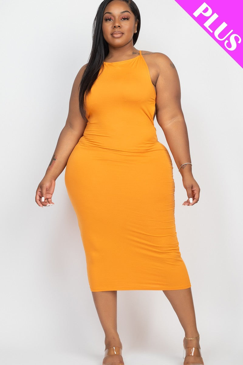 A stylish plus-size woman wearing a Tomato Cream Plus Open Back Criscross Maxi Fashion Dress, showcasing its soft fabric and elegant design.