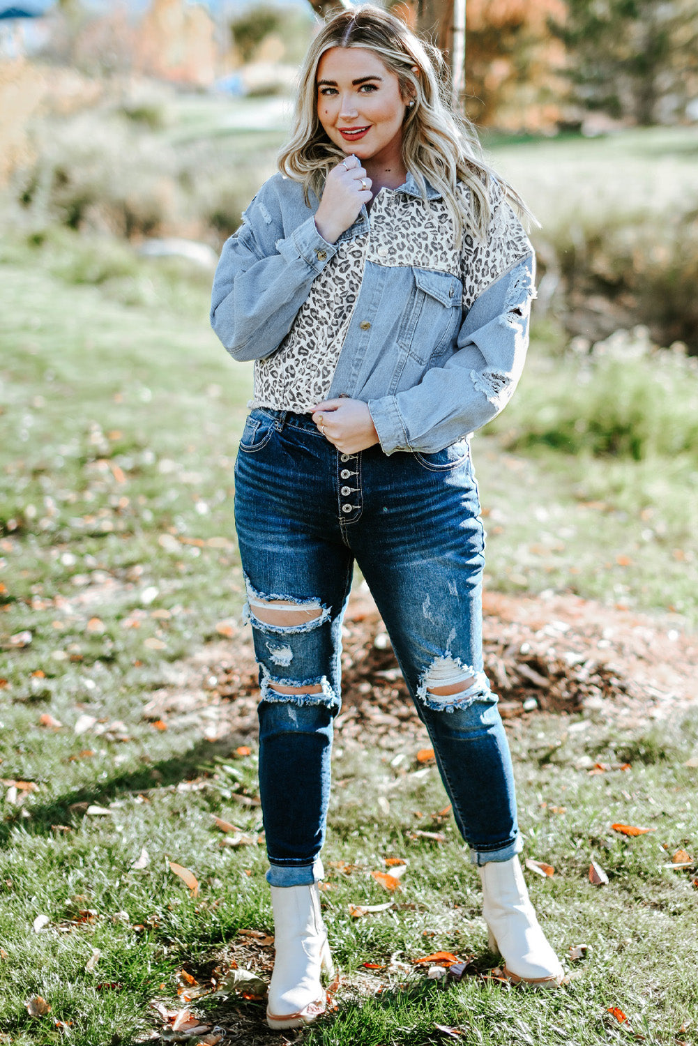 Plus size denim jacket featuring leopard print, distressed details, and raw hem, perfect for casual outdoor wear.