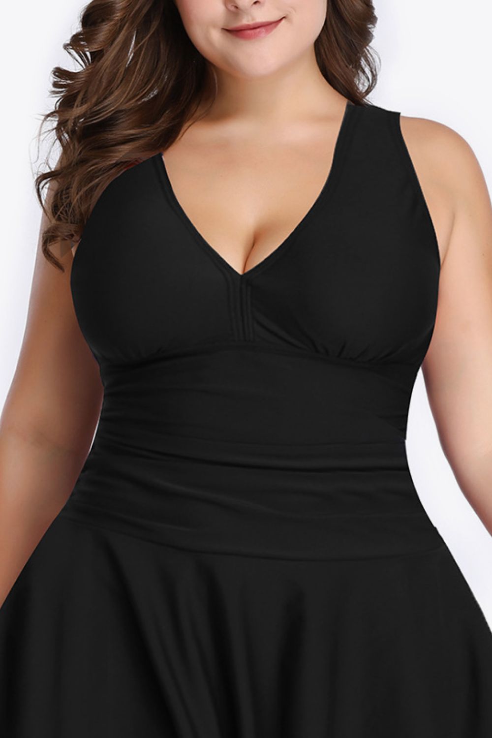 A stylish plus size plunge swim dress featuring a solid pattern, no underwire design, and removable padding, perfect for summer outings.