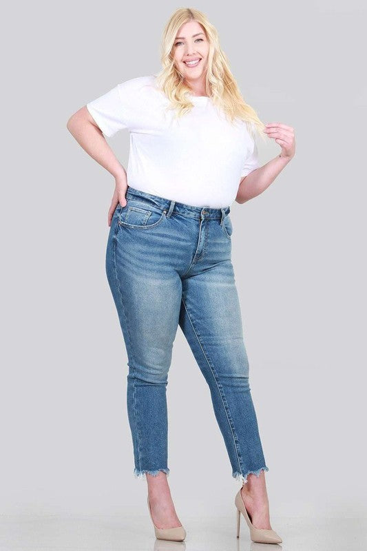 A pair of plus size relaxed skinny jeans featuring a high rise, zipper fly, ankle length with raw cut hem, and five pocket styling.